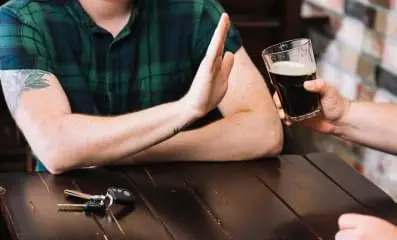 Man refusing alcohol.