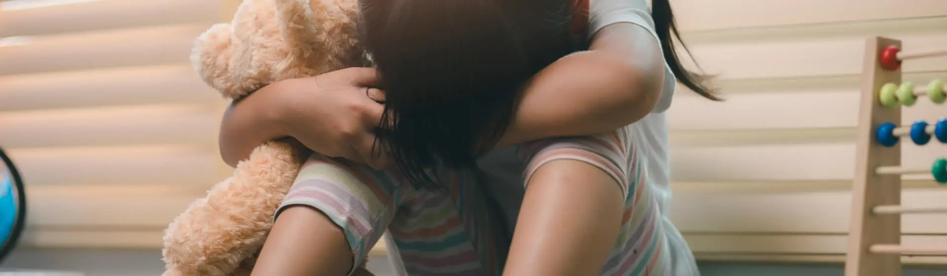 Kid in foster care sad with head down