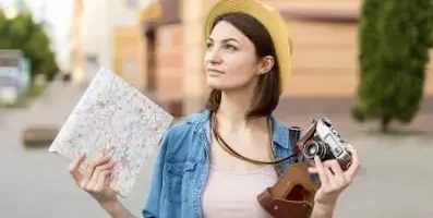 Tourist with map and camera.