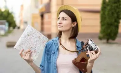 Tourist with map and camera.
