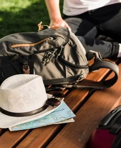 Hat and backpack on bench.
