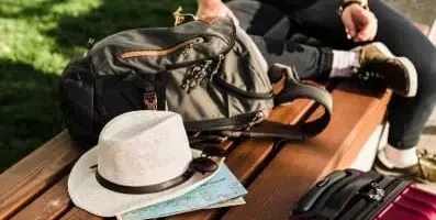 Hat and backpack on bench.