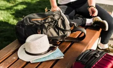 Hat and backpack on bench.