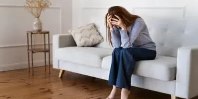 Frustrated woman with head down.