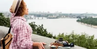 Woman staring into lake.