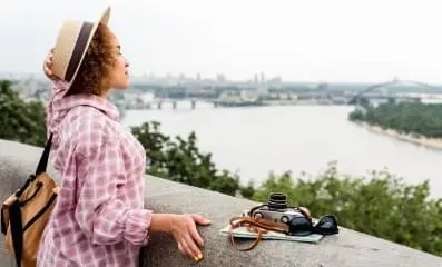 Woman staring into lake.