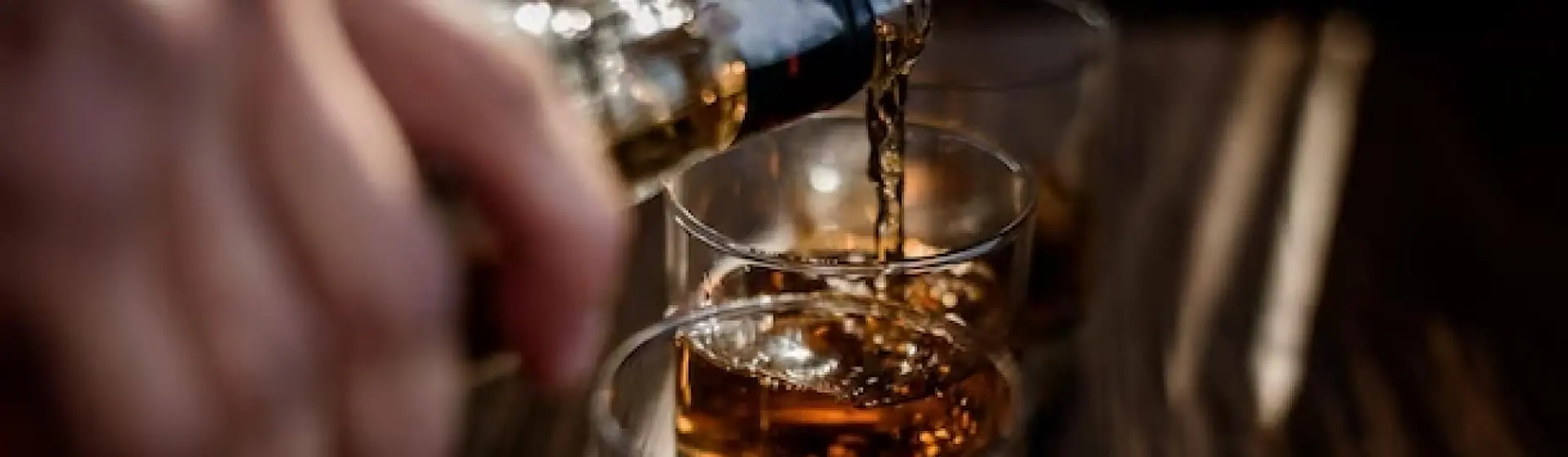 poring alcohol into glass.