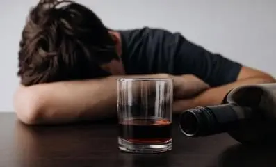 Drunk man on table.