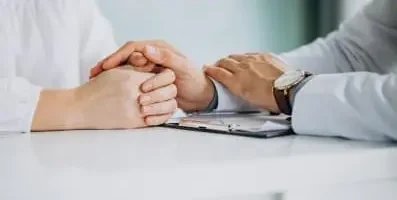 Doctor holding patient hands