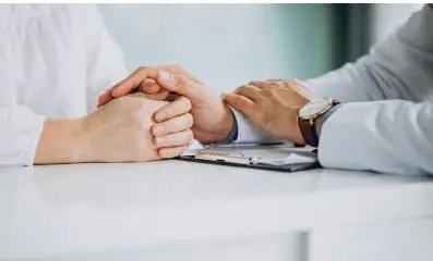 Doctor holding patient hands