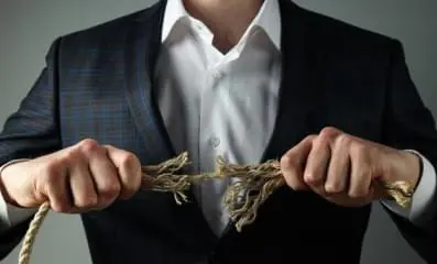 Man pulling apart ropes ripping it.