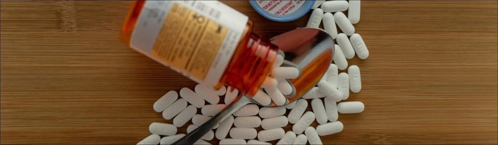 Pills spilled onto a spoon. In 2020 alone, there were over 1,500 opioid-related overdose deaths in the state.