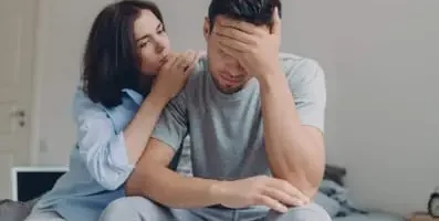 Wife comforting husband. Understand and recognize the symptoms of depression in order to know what to say and do in order to offer support.