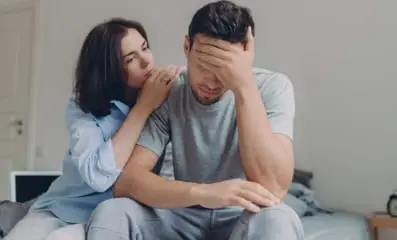 Wife comforting husband. Understand and recognize the symptoms of depression in order to know what to say and do in order to offer support.