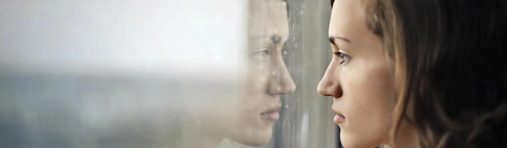 Woman staring outside of window