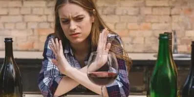 Woman saying no to alcohol.