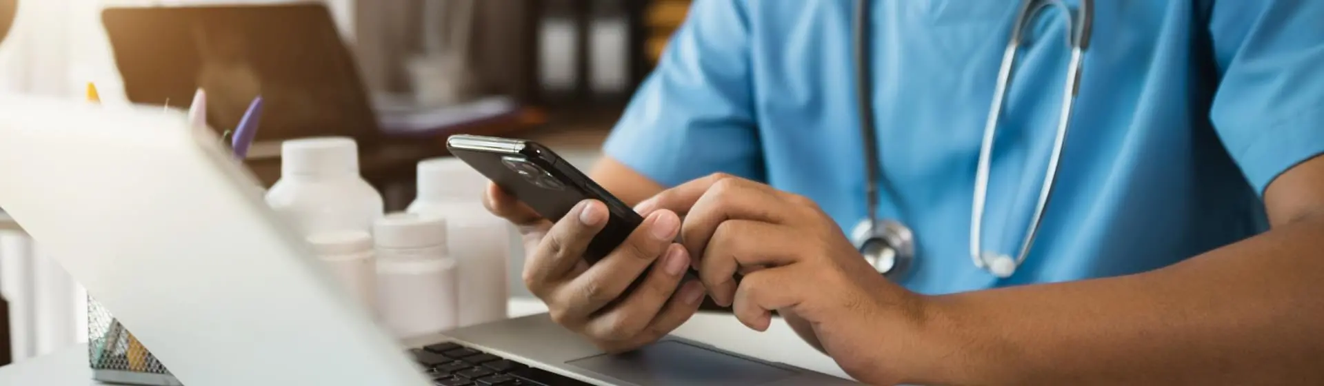 Doctor typing on his phone