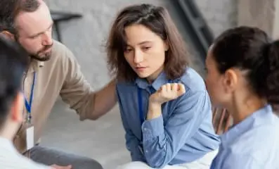 Woman with drug addiction being helped by therapist