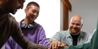 A group of people staking their hands.