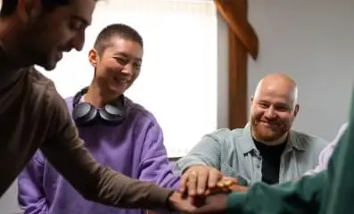 A group of people staking their hands.