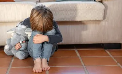 Image: Child crying. Text: Childhood trauma has a negative impact on the brain and physiological reactions throughout the body.