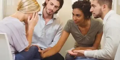 A group of people supporting a friend.