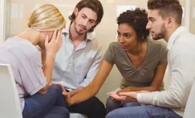 A group of people supporting a friend.