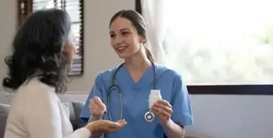 Nurse speaking with patient.