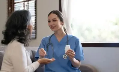 Nurse speaking with patient.