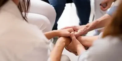 A group of people holding hands.