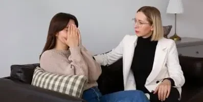 Therapist supporting a patient crying.