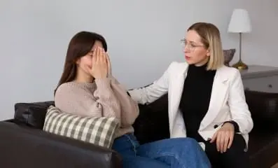 Therapist supporting a patient crying.