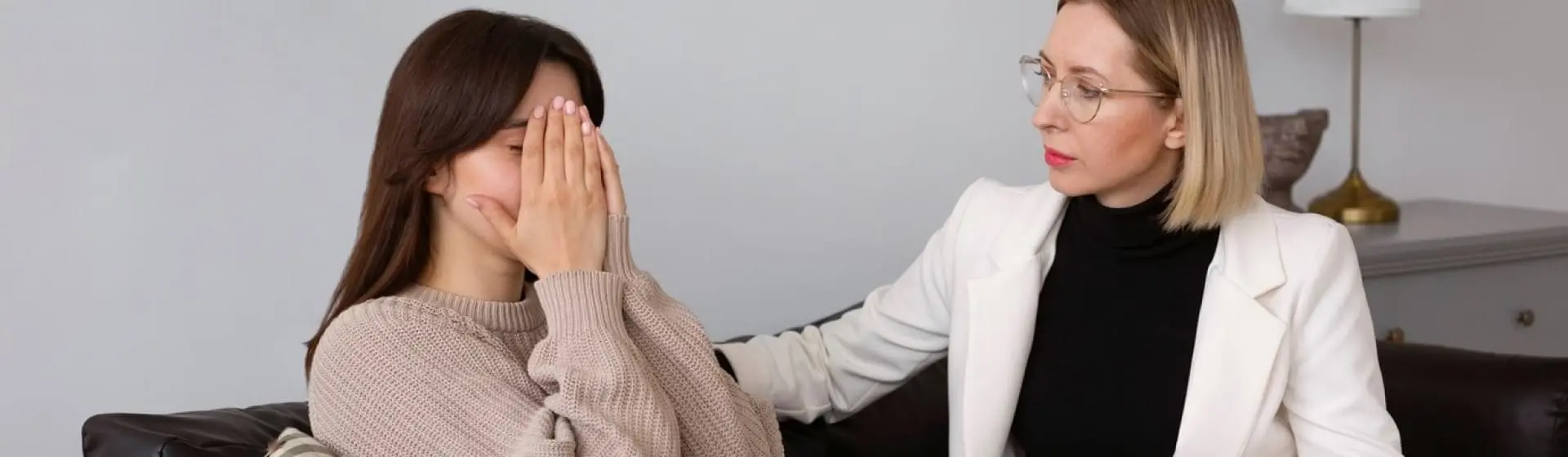 Therapist supporting a patient crying.