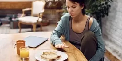 Woman not eating her lunch because of eating disorder.