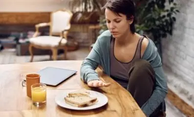 Woman not eating her lunch because of eating disorder.