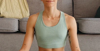 woman meditating peacefully in an all green outfit