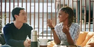 Woman speaking to man over coffee.