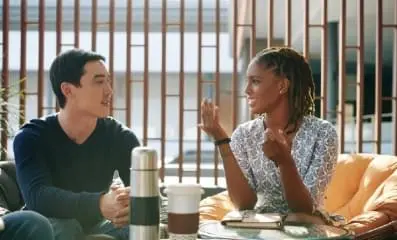 Woman speaking to man over coffee.