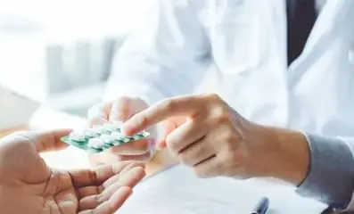 Doctor prescribing pills.
