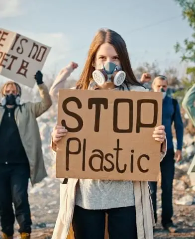 A group of people protesting holding signs.