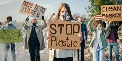 A group of people protesting holding signs.