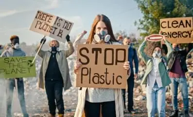 A group of people protesting holding signs.