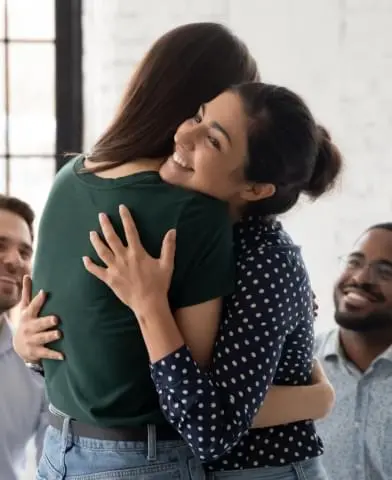 Image of two women hugging.