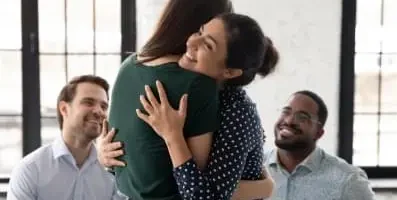 Image of two women hugging.