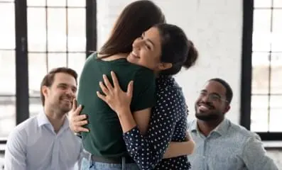 Image of two women hugging.
