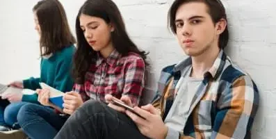 A group of teens sitting together.