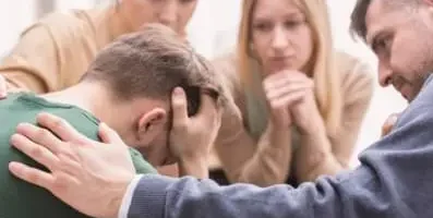 A group of people supporting one person.