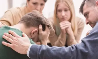 A group of people supporting one person.