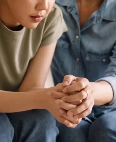 Closeup of a supportive hand hold.