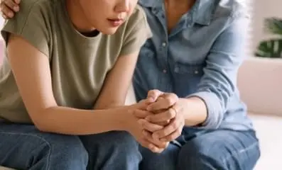 Closeup of a supportive hand hold.